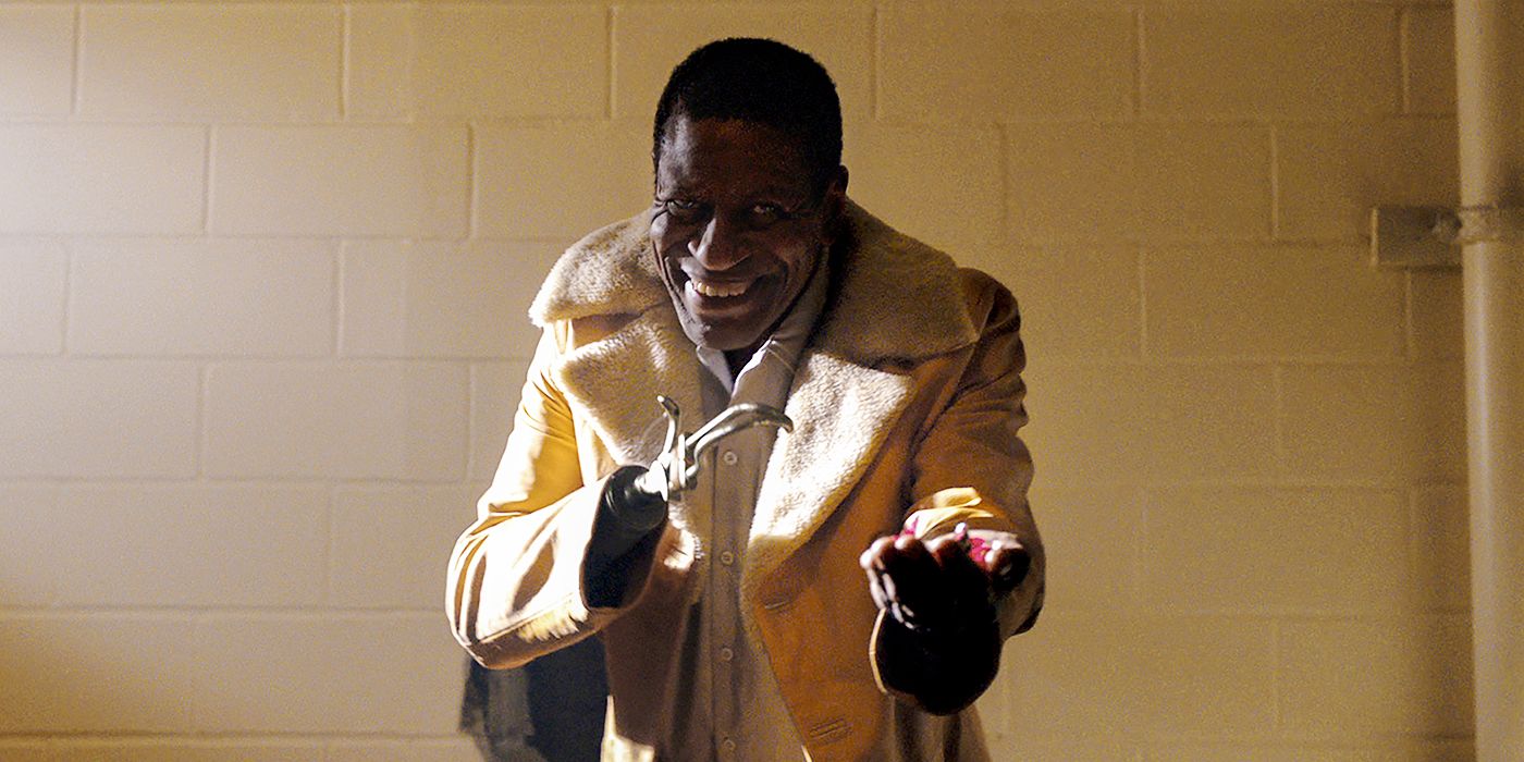 The Sherman Fields Candyman extending his hand offering candy in 2021's Candyman.