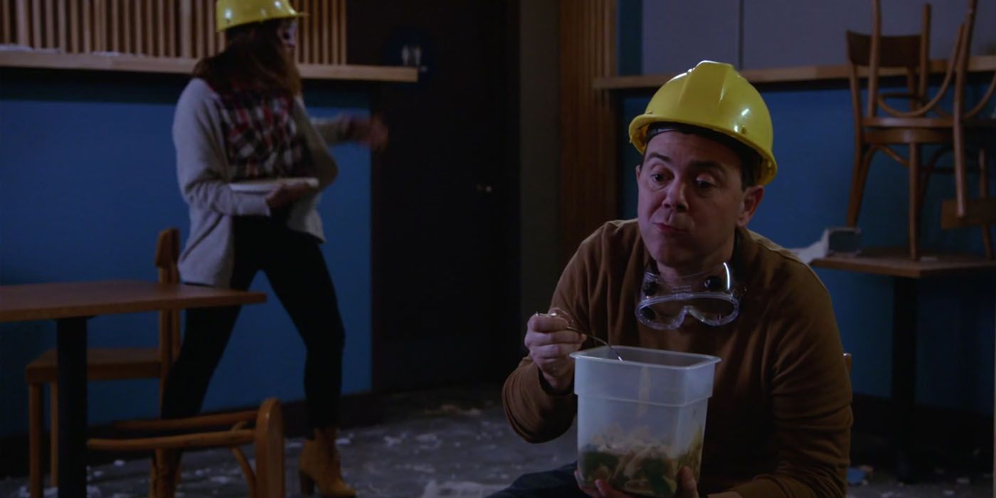 Charles wearing a hard hat and eating leftovers in Brooklyn Nine Nine