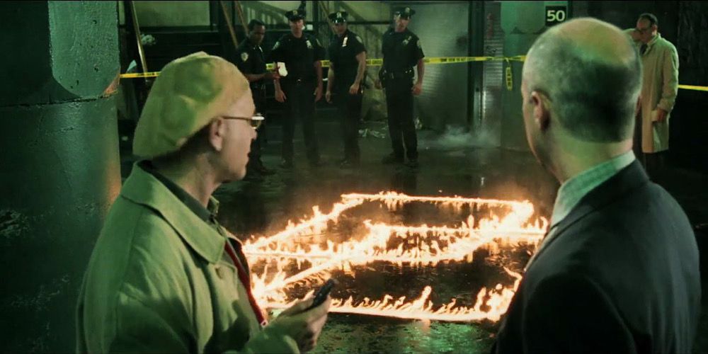 The Daredevil logo on fire on the floor of the subway in Daredevil