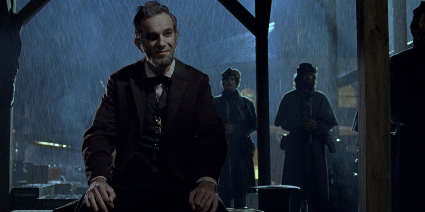 Daniel Day Lewis as Lincoln sitting while it rains behind him.