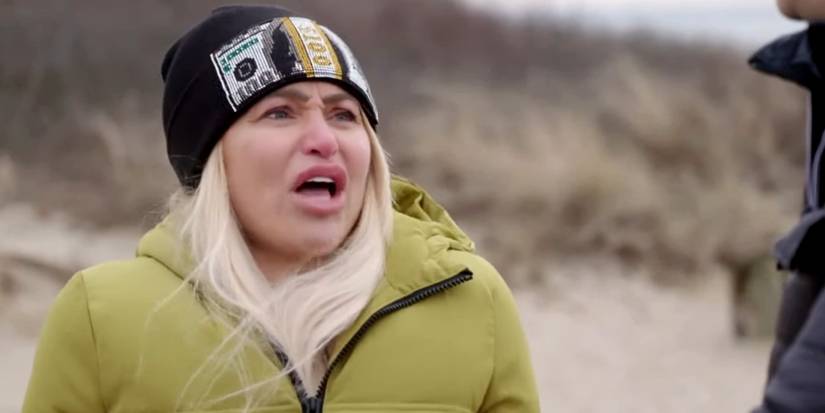 Darcey Silva in 90 Day Fiance wearing green jacket and black beanie with her mouth open
