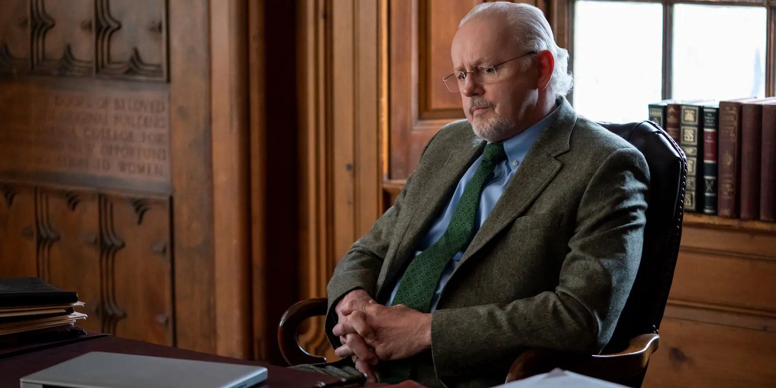 Dean Paul-Larson sitting on his chair in his office in in The Chair on Netflix