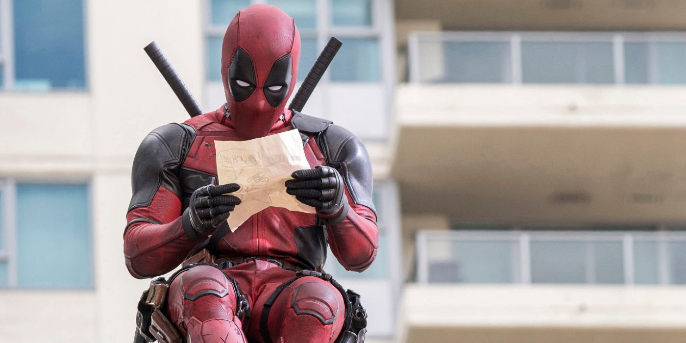 Deadpool drawing a picture on a ledge