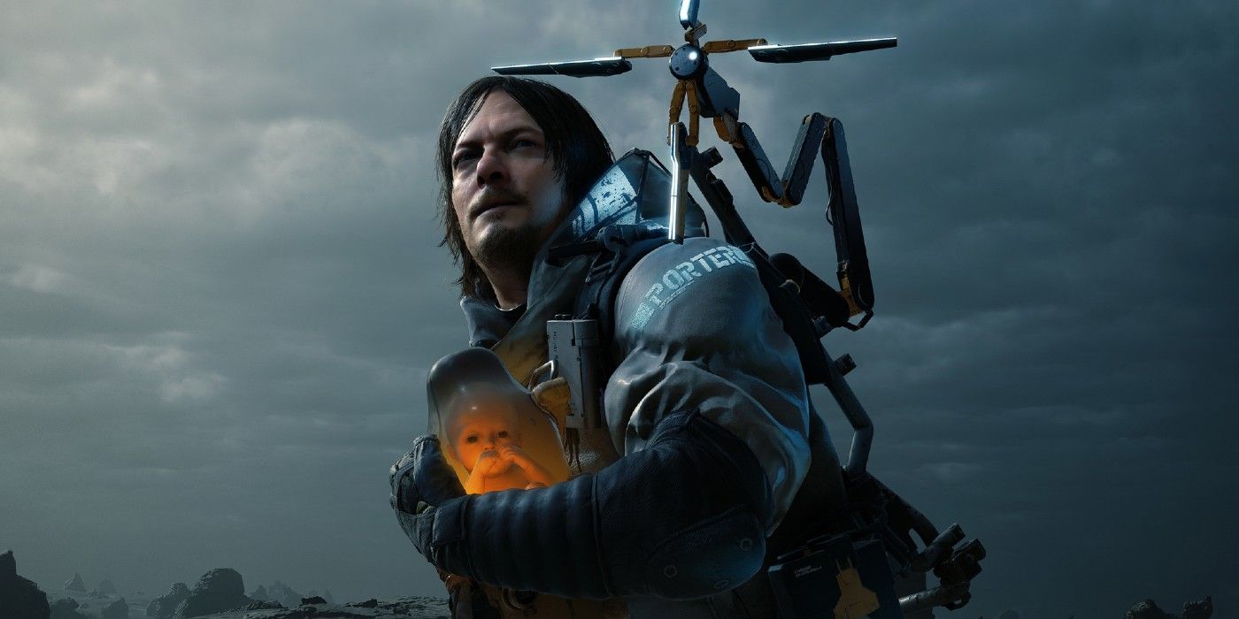 A photo of Sam looking at something offscreen as he holds BB in the game, Death Stranding.