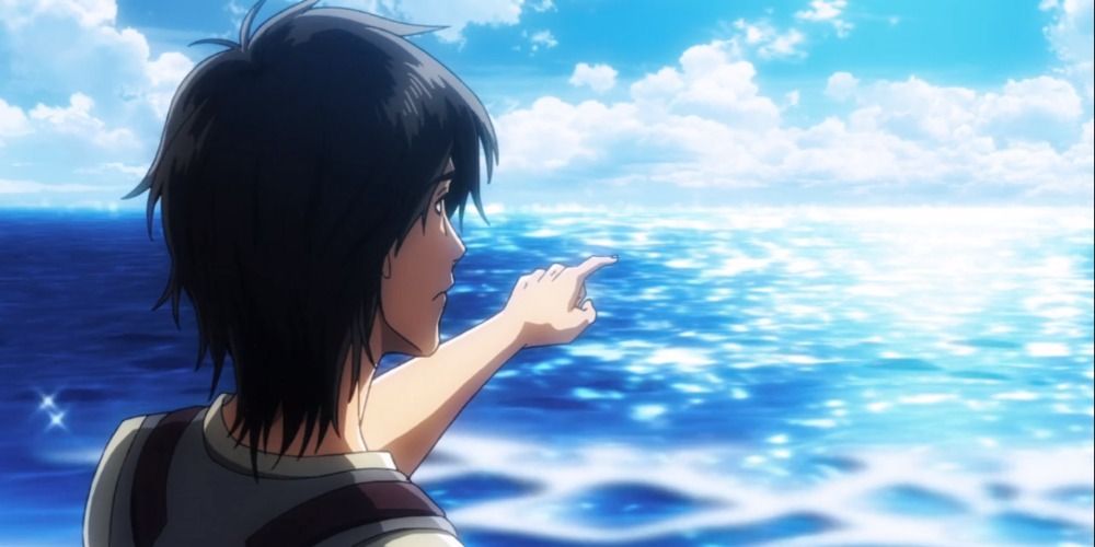 Eren Jaeger dari Attack on Titan menunjuk ke lautan biru yang luas