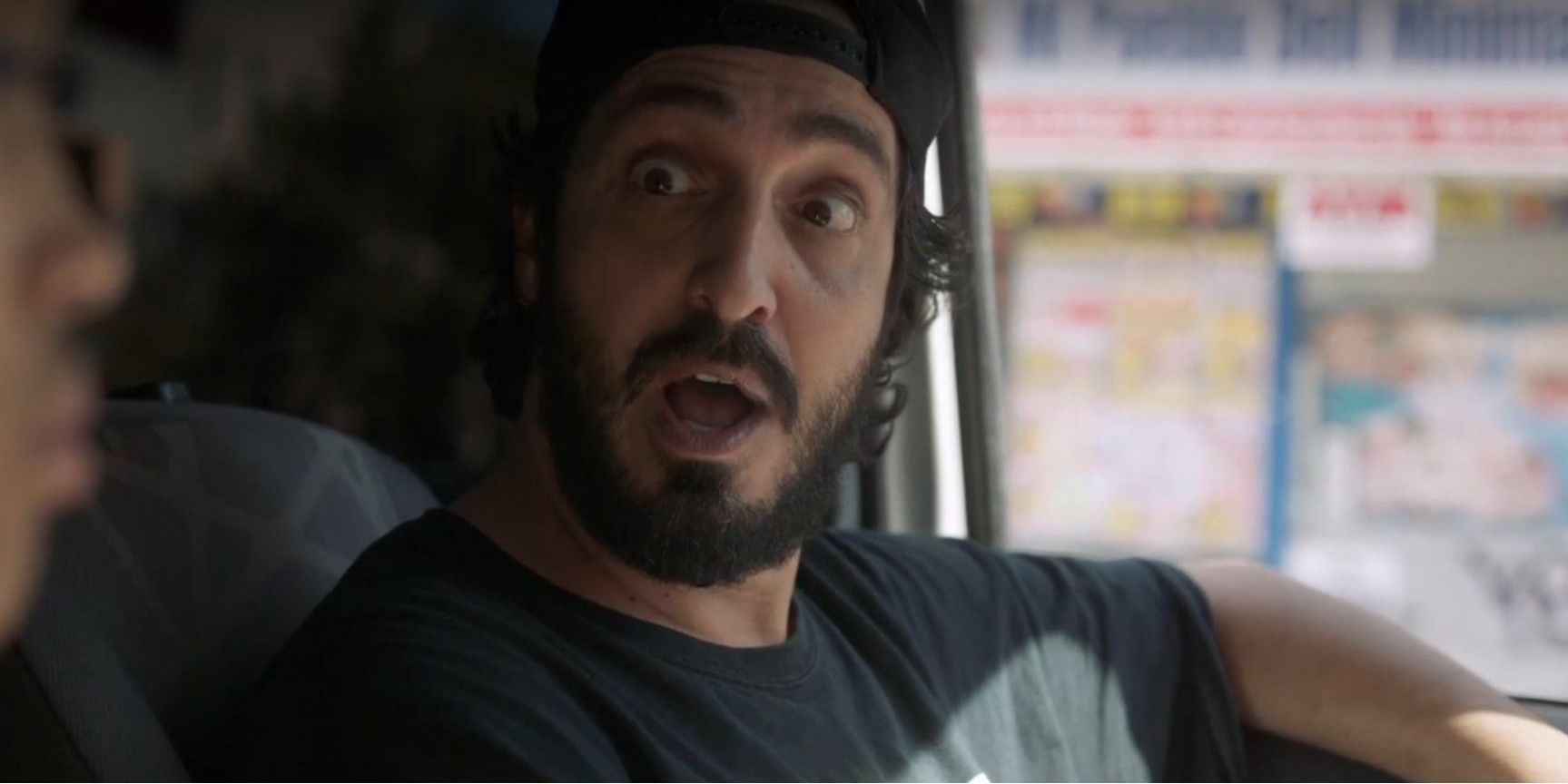 Farouk sitting in a car looking surprised in Betty