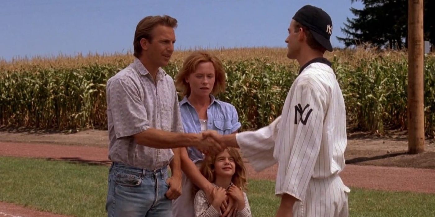 Ray Kinsella (Kevin Costner) with his family, shaking hands with John (Dwier Brown) in Field of Dreams.