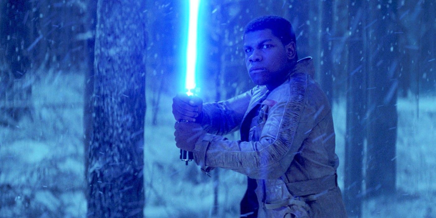 Finn holds a blue lightsaber on Starkiller base and faces off with Kylo Ren in The Force Awakens