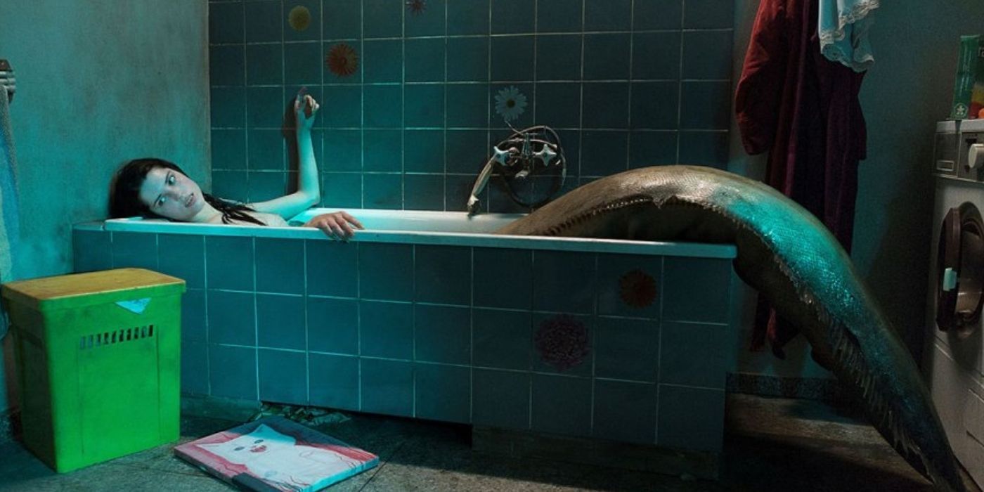 Golden the mermaid laying in a bathtub in a still from The Lure