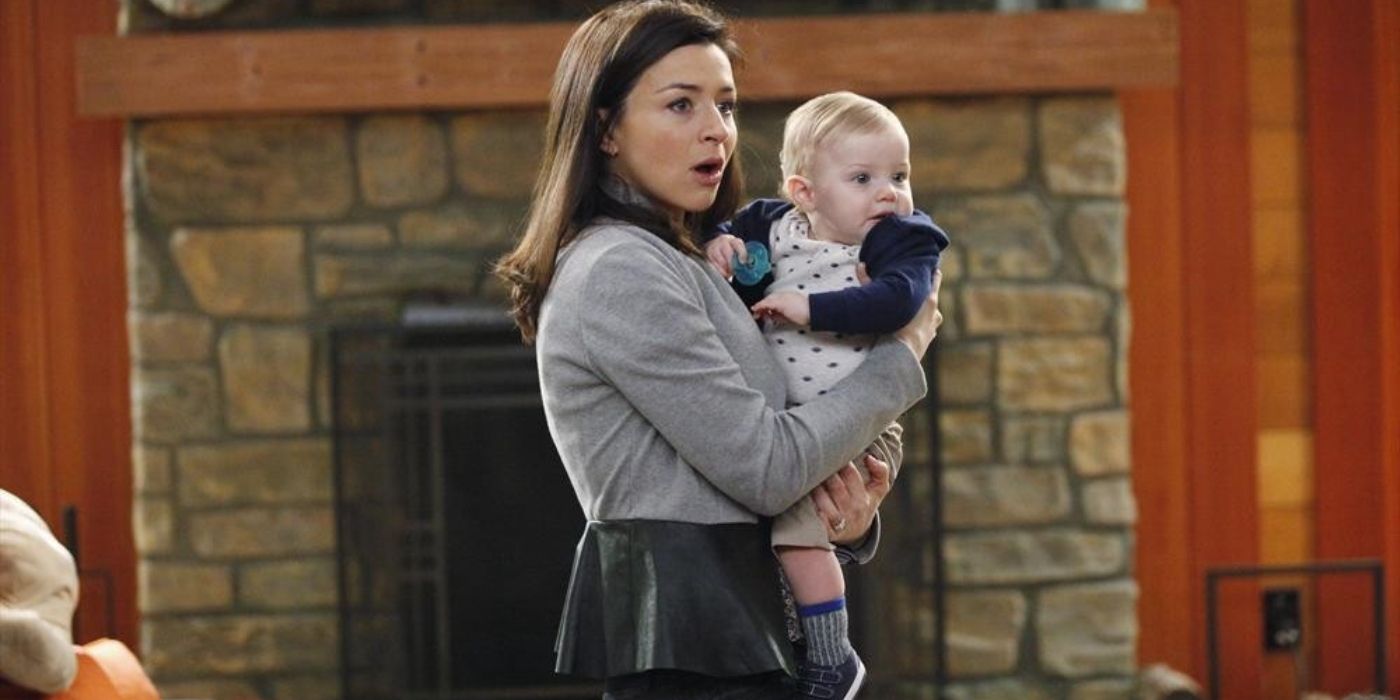 Amelia looking surprised while holding Meredith's baby on Grey's Anatomy