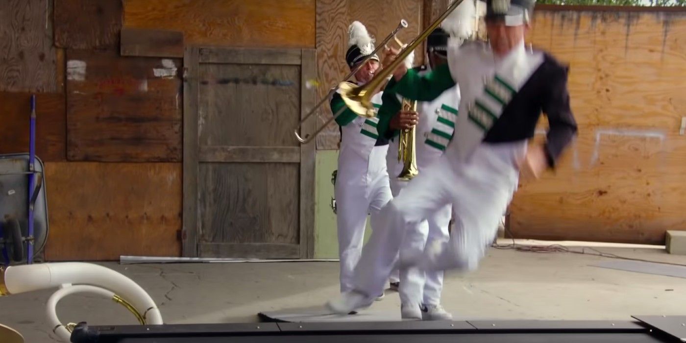 A marching band steps onto a treadmill in Jackass Forever