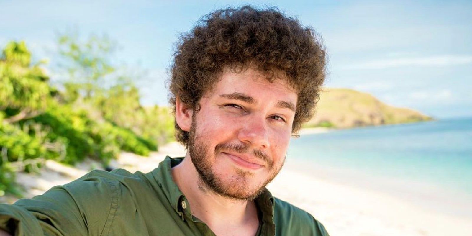 Jacob from Survivor smirking at the camera