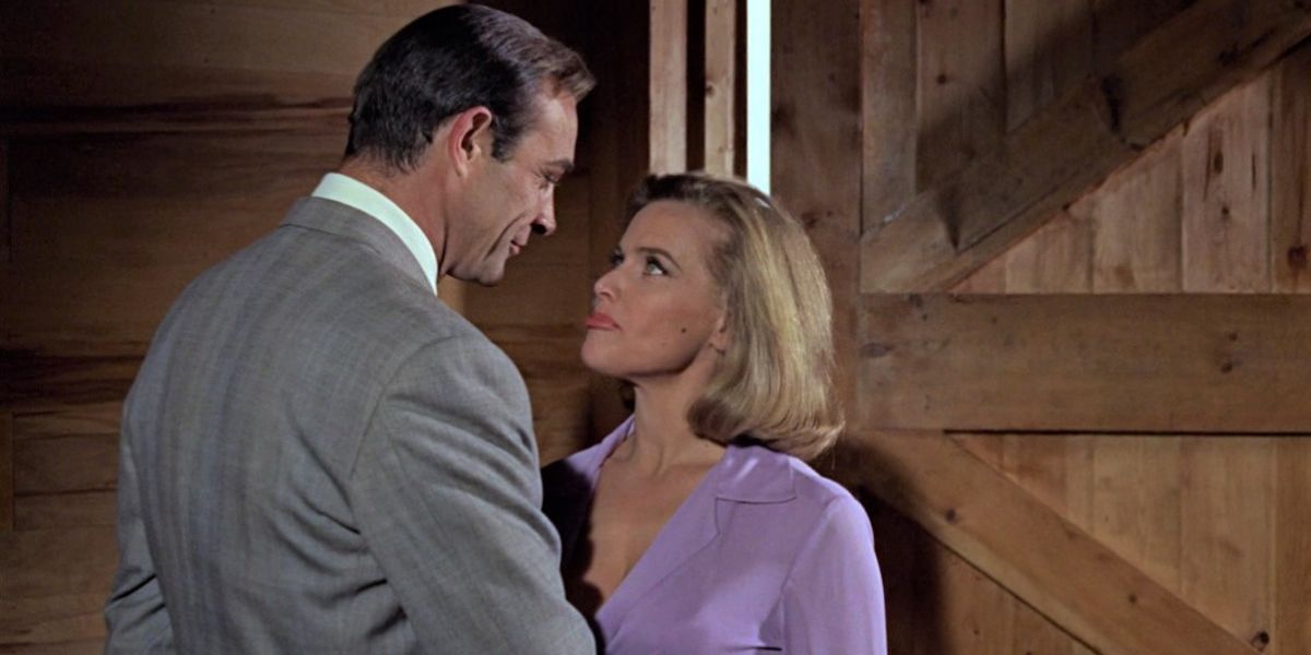 James Bond and Pussy Galore standing in a barn in Goldfinger