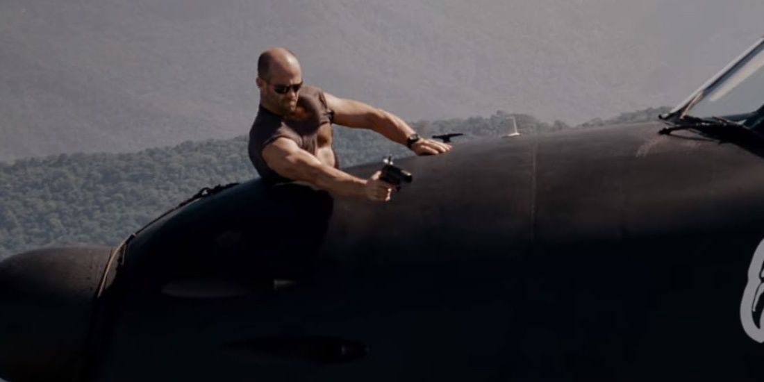 Jason Statham shooting flare from plane in The Expendables 