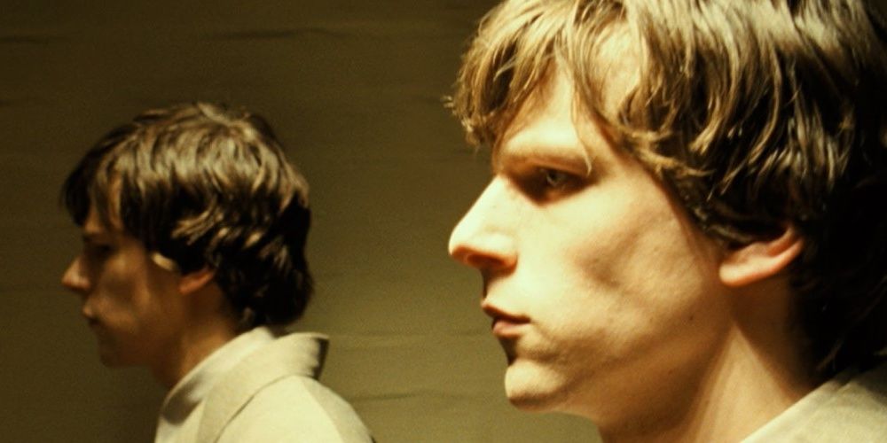 Jesse Eisenberg and his double looking sideways in The Double 