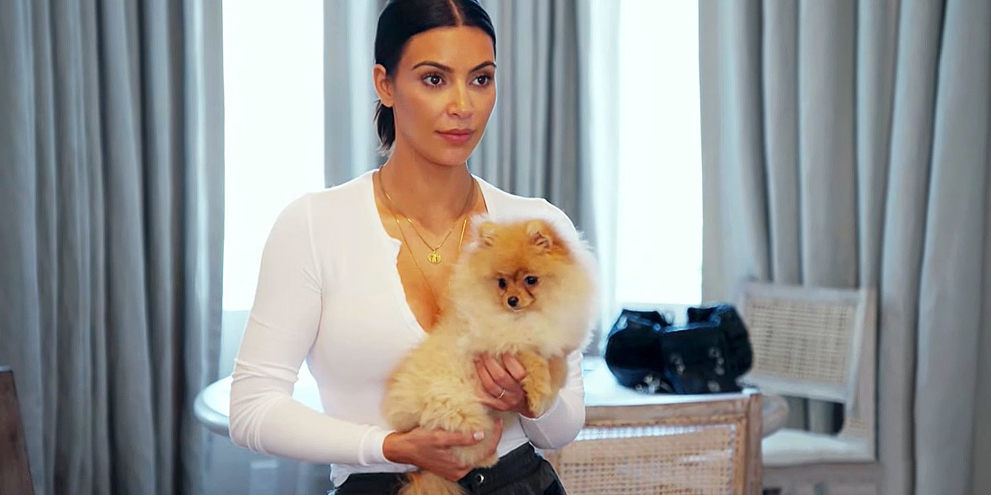Kim holds Kourtney's dog on Keeping Up With The Kardashians