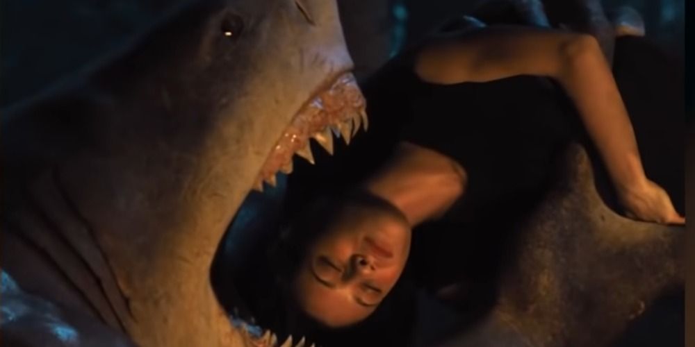 King Shark in The Suicide Squad lifting up Ratcatcher 2 to eat her