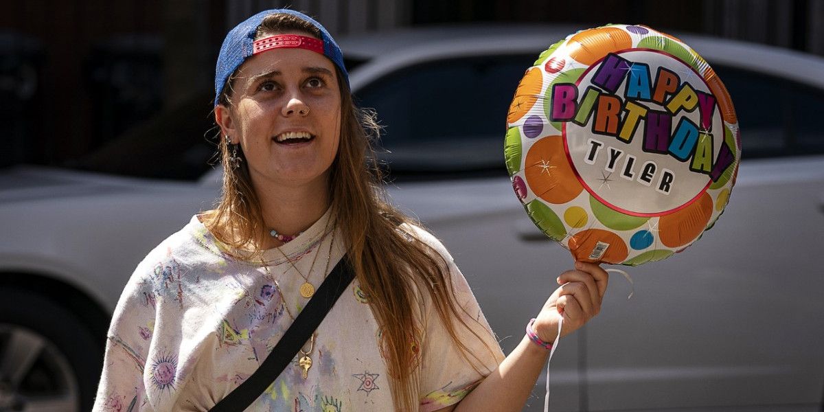 Kirt holding a birthday balloon in Betty