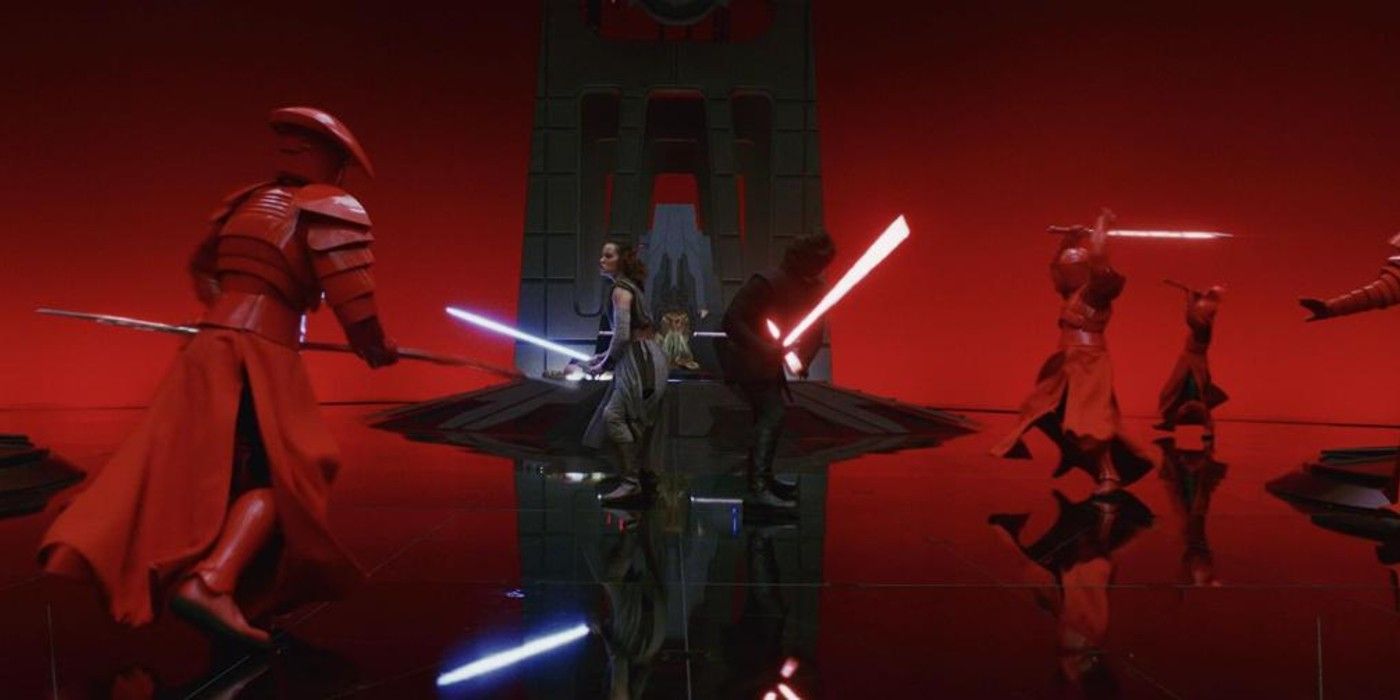 Rey and Kylo Ren fight Praetorian Guards in Snoke's throne room.