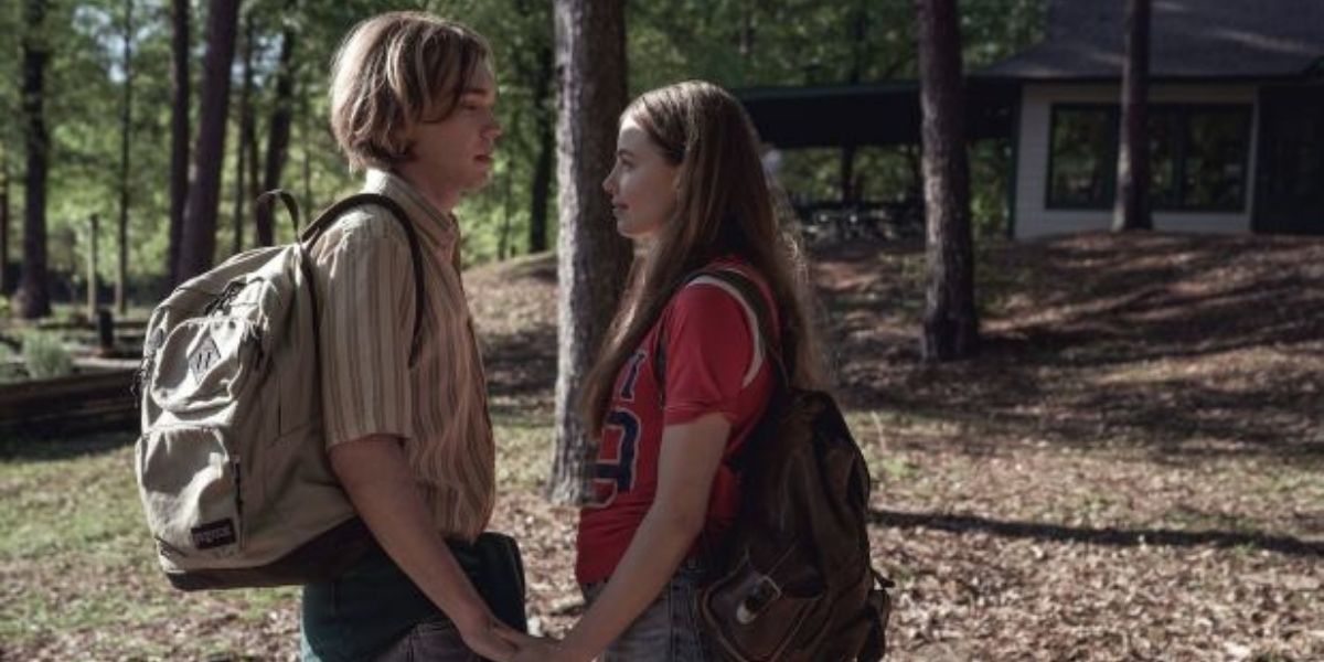 Looking for Alaska: Miles and Alaska holding hands in the woods