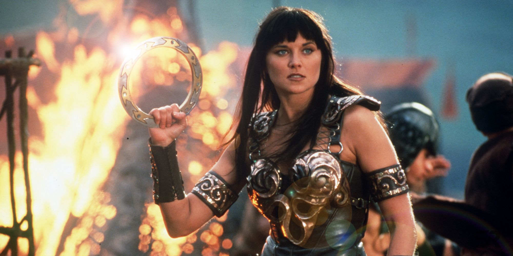 Xena standing in the middle of a battle in Xena Warrior Princess