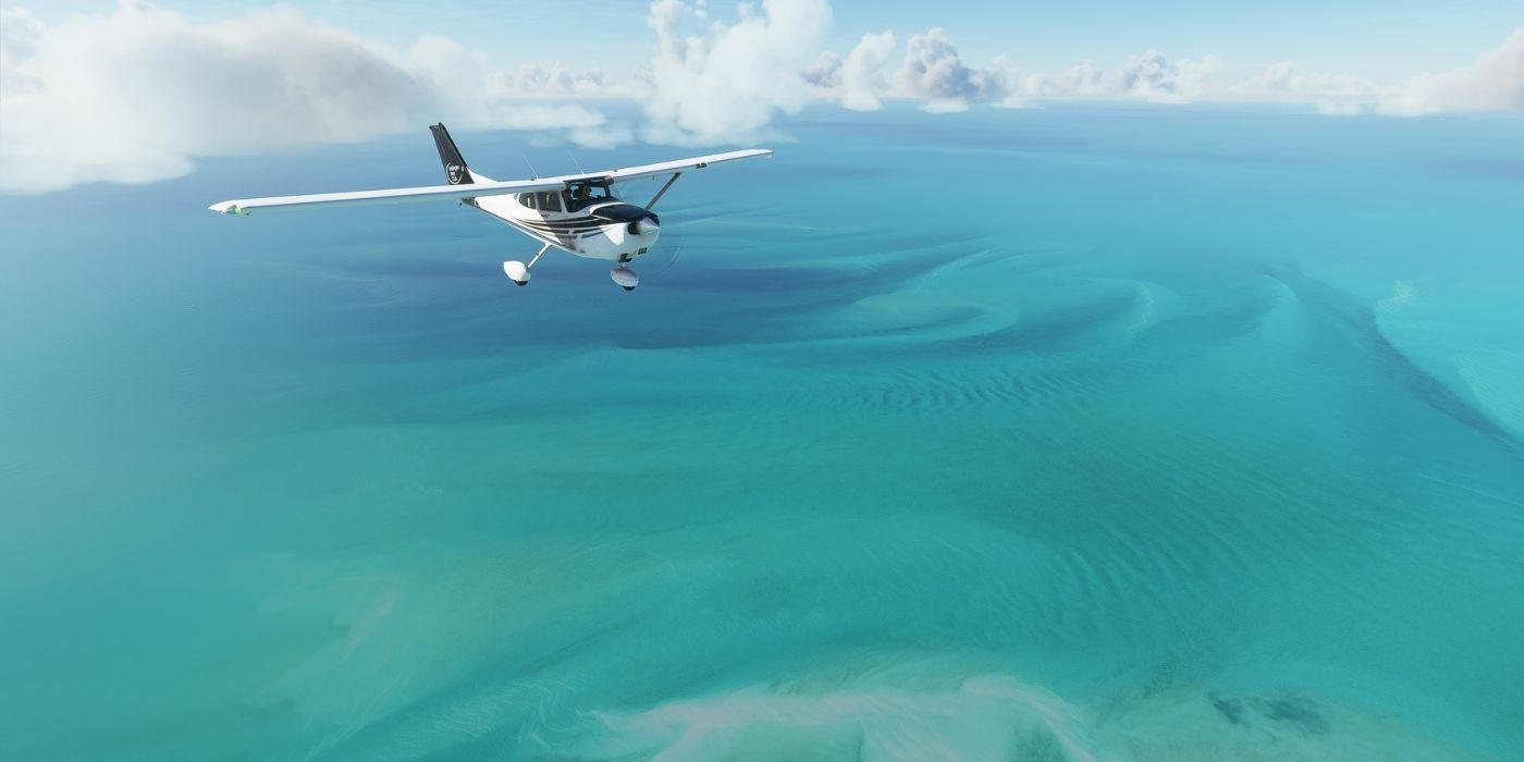 A plane flying over the ocean in the Microsoft Flight Simulator.