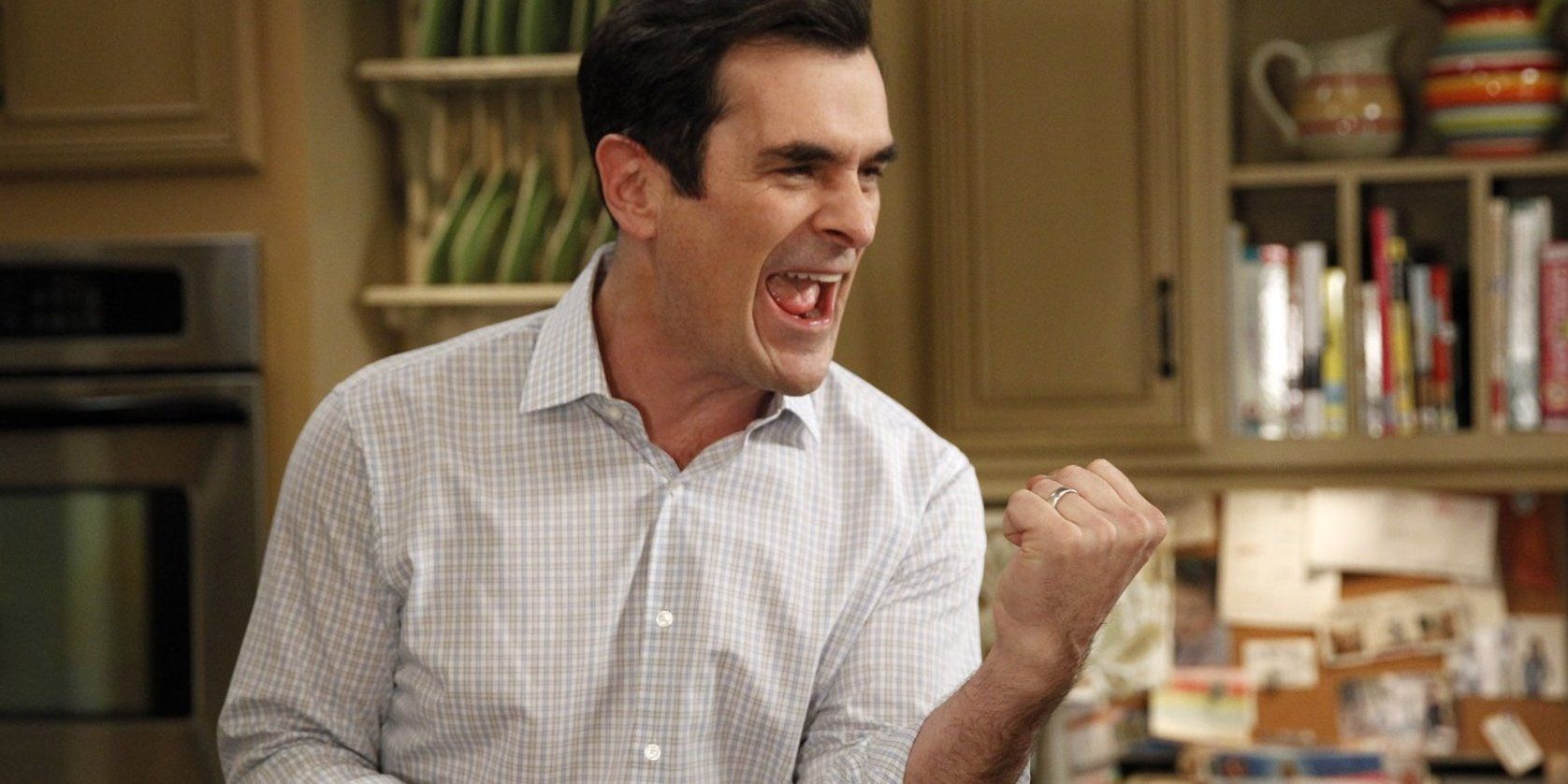 Phil Dunphy cheering in his kitchen in Modern Family