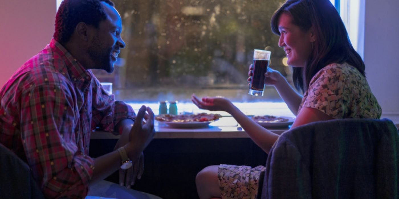 A couple talk and laugh in a dark dinner in Modern Love season 2.