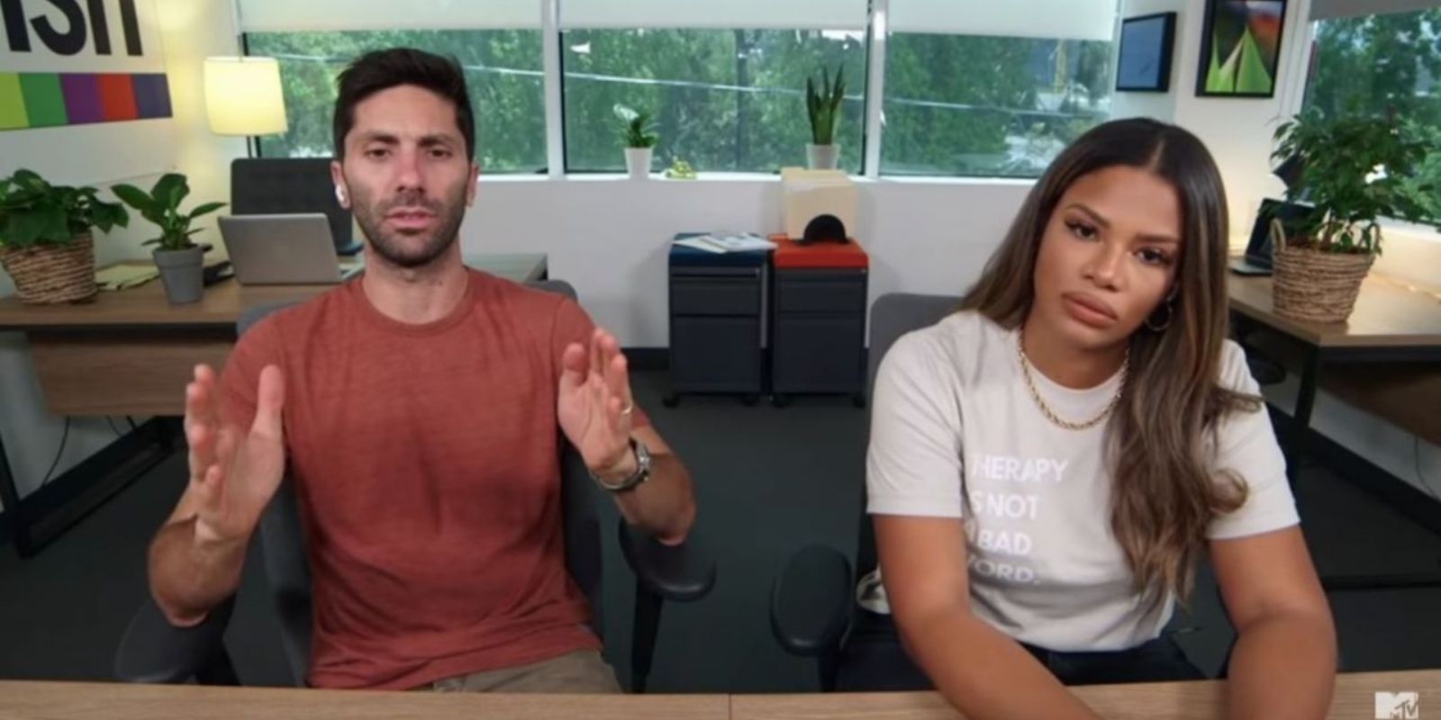 Nev Schulman gestures in disblief and Kamie Crawford looks wary in MTV's Catfish