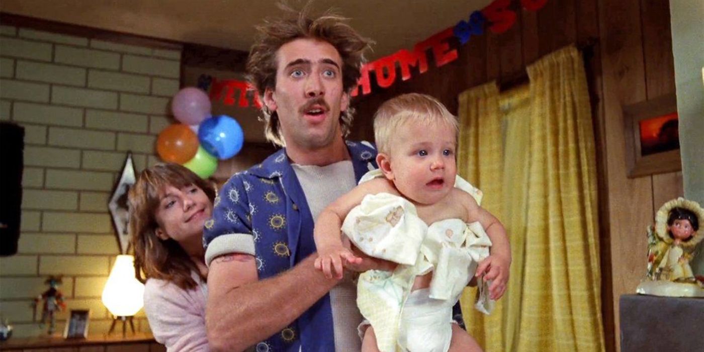 Nic Cage holding up a kidnapped baby in Raising Arizona.