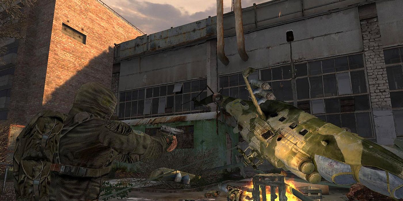 A soldier finds a downed helicopter outside Chernobyl in STALKER: Shadow of Chernobyl