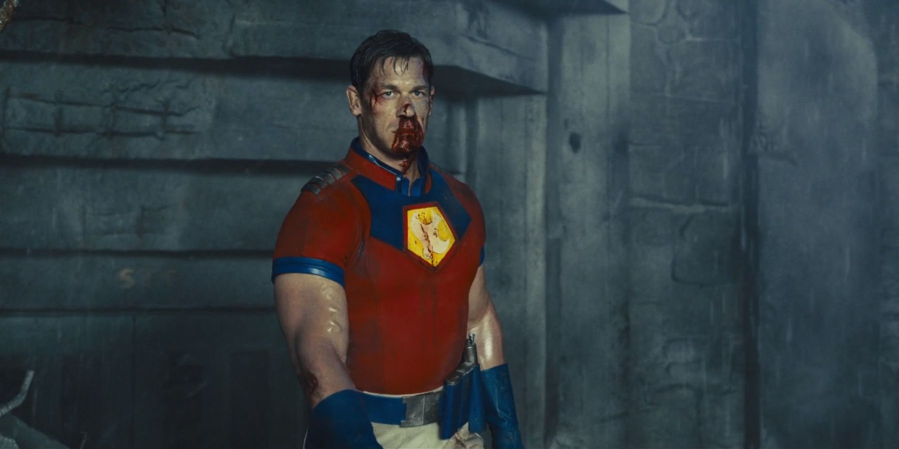 Peacemaker bloodied and beaten without his helmet in Jotunheim in James Gunn's The Suicide Squad