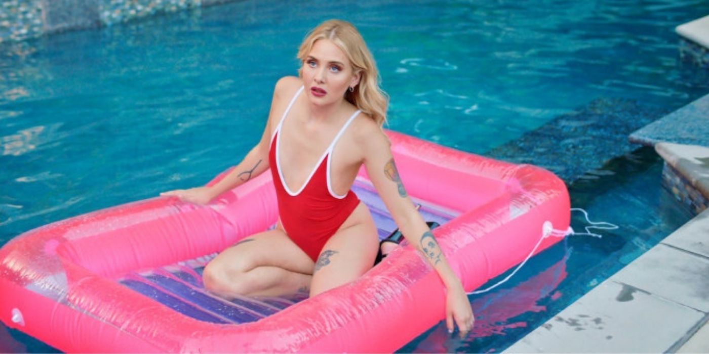 A blonde woman on a floaty in a pool