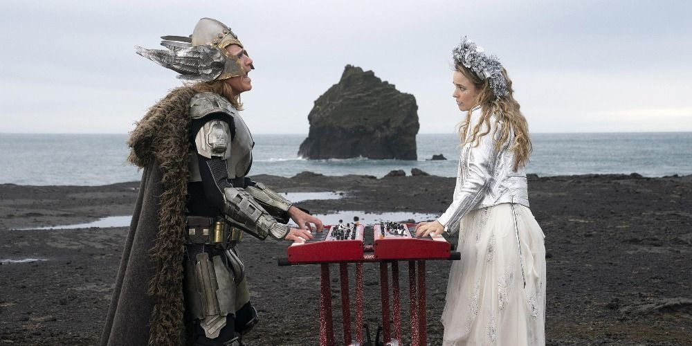 Rachel McAdams and Will Ferrell in Eurovision Song Contest The Story of Fire Saga dressed in costumes standing on a beach playing twin keyboards