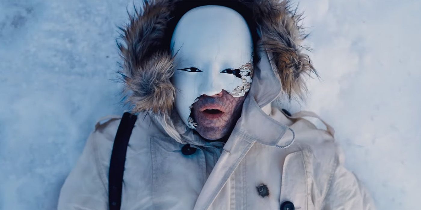 Rami Malek wearing a mask in the snow in No Time to Die 