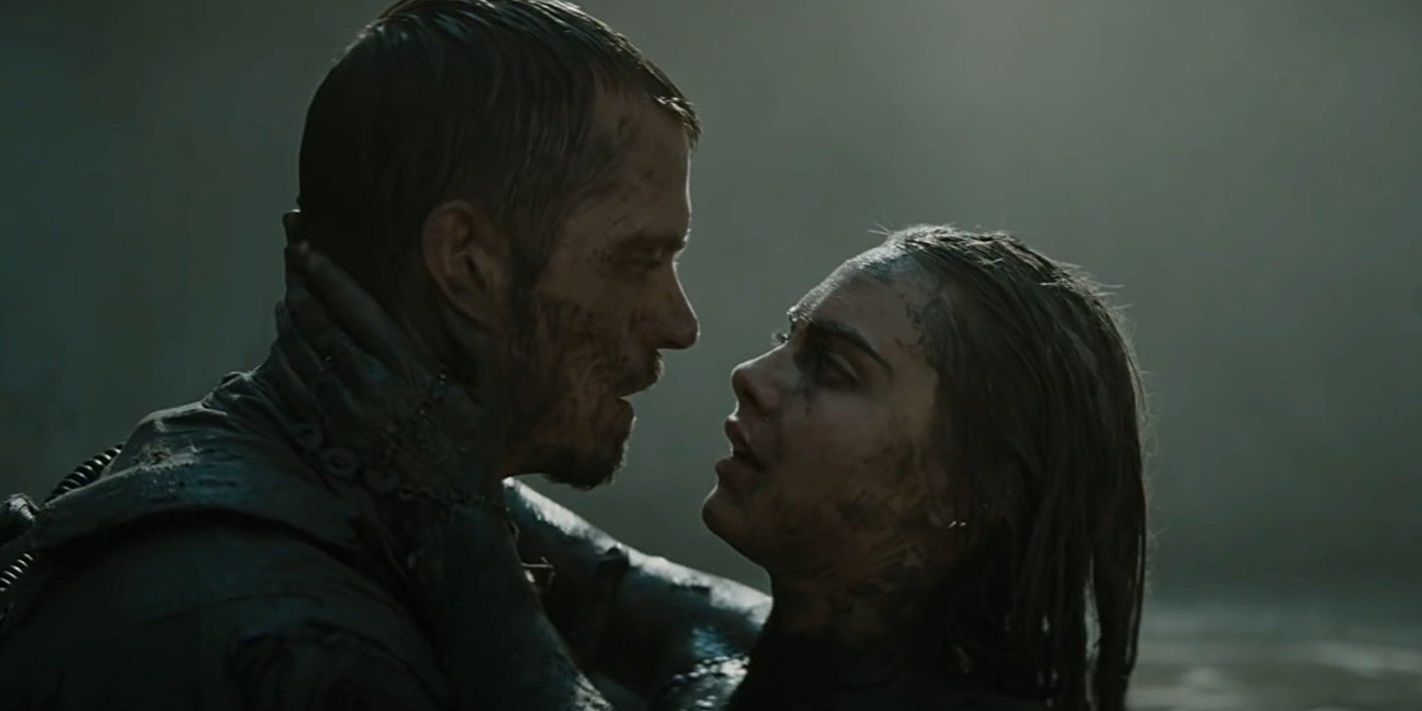 Rick Flag and June Moon hug in the mud in Suicide Squad