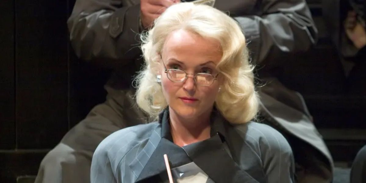 Rita Skeeter holding a pad and quill at a trial from Harry Potter