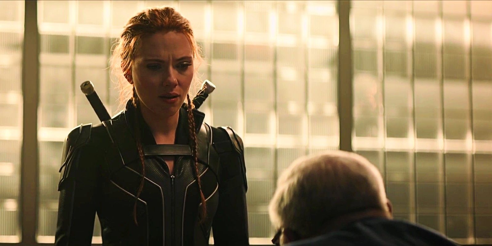 Black Widow standing during the confrontation with Dreykov in his office in Black Widow