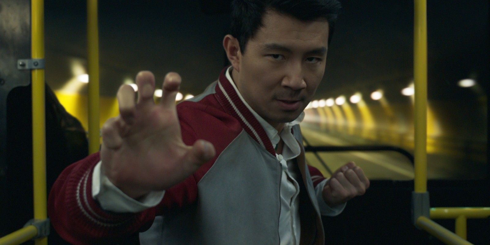 Shang-Chi holds up his fist and prepares to fight