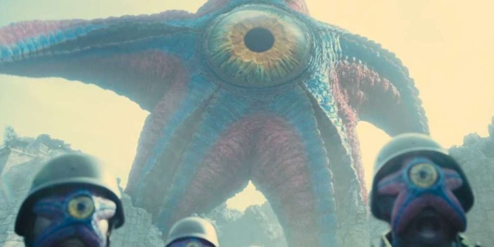 Starro and his army in The Suicide Squad on the ground are several people with starfish on their faces
