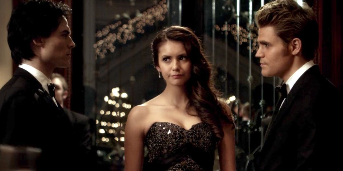 Stefan, Damon, and Elena standing together dressed in fancy evening wear on The Vampire Diaries