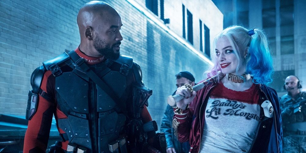 Deadshot and Harley Quinn look at each other in the street in Suicide Squad