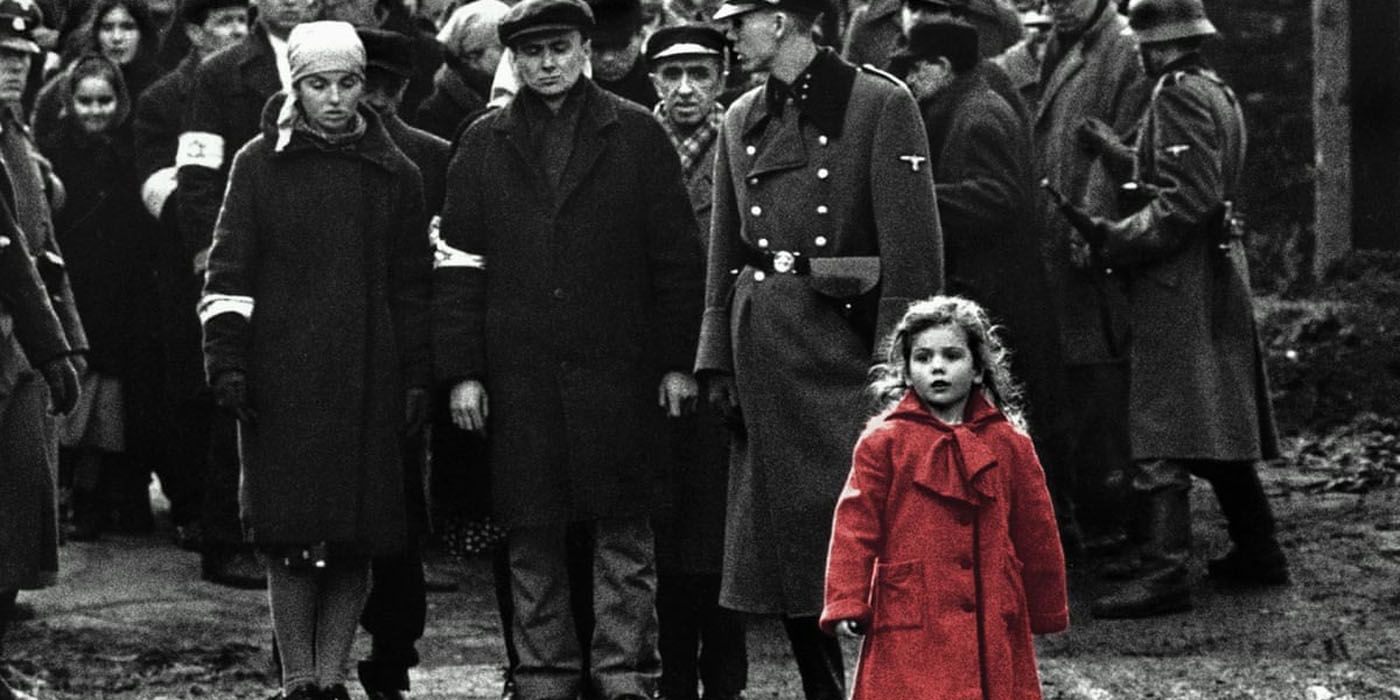 A black and white crowd following a little girl in a red coat in Schindler's List