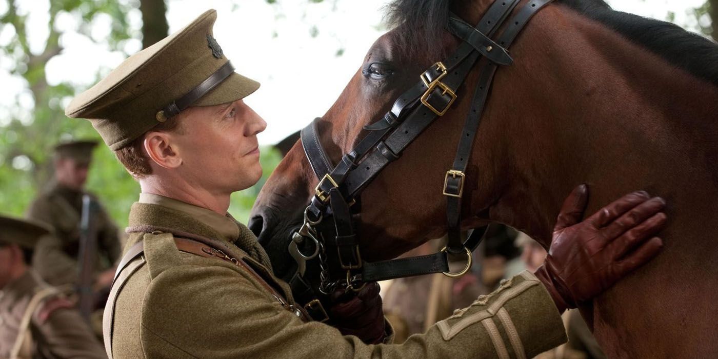 Tom Hiddleston petting a horse in War Horse.