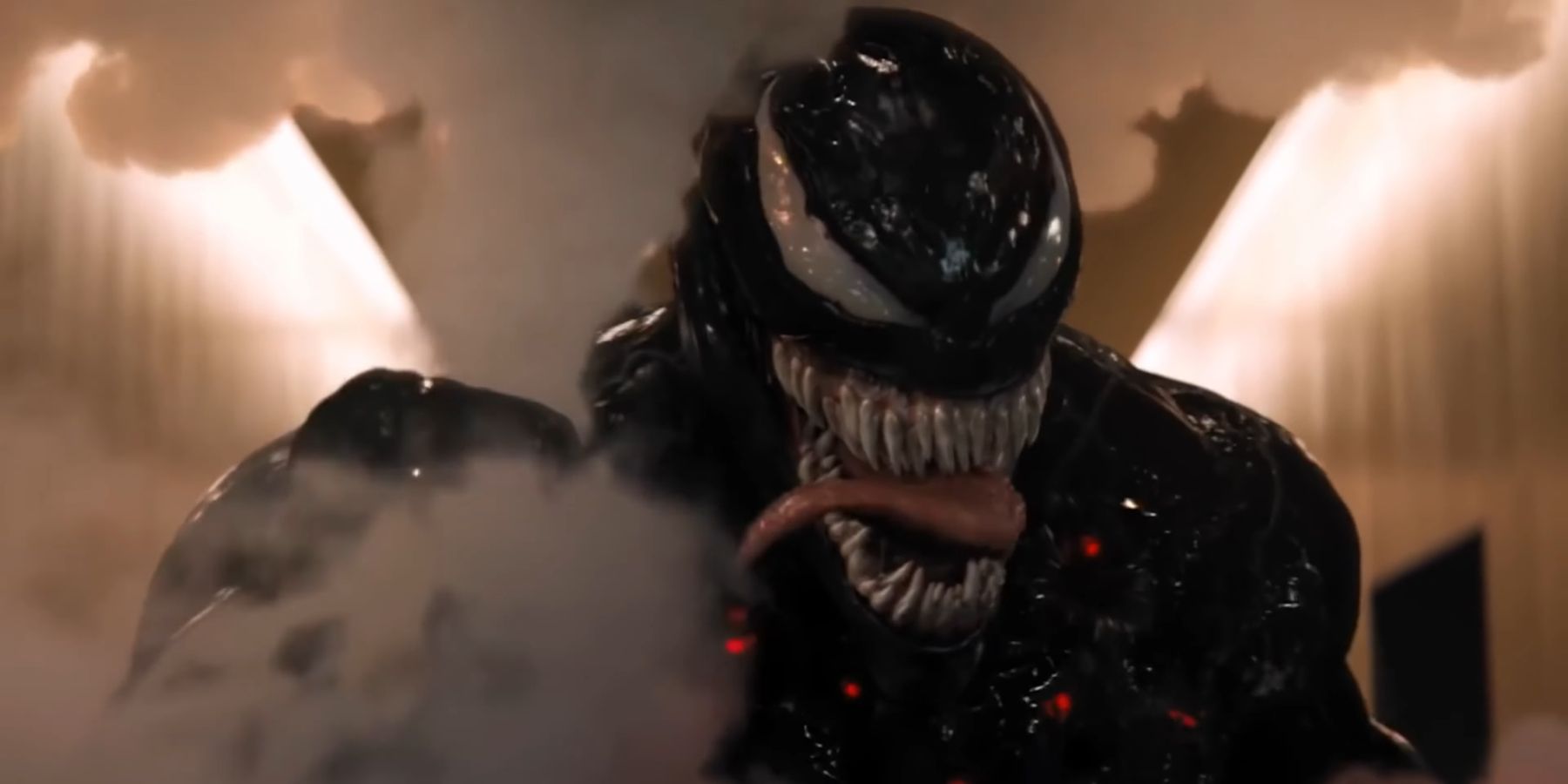Venom snarling while crushing a smoke bomb in Venom