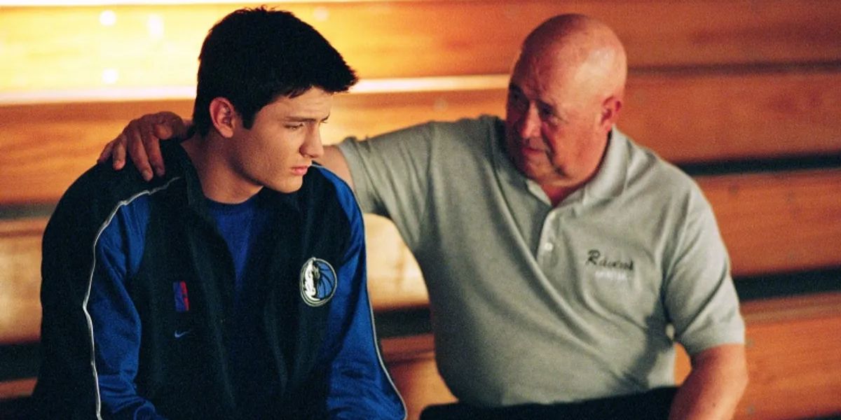 Whitey Durham comforts a basketball player in One Tree Hill.
