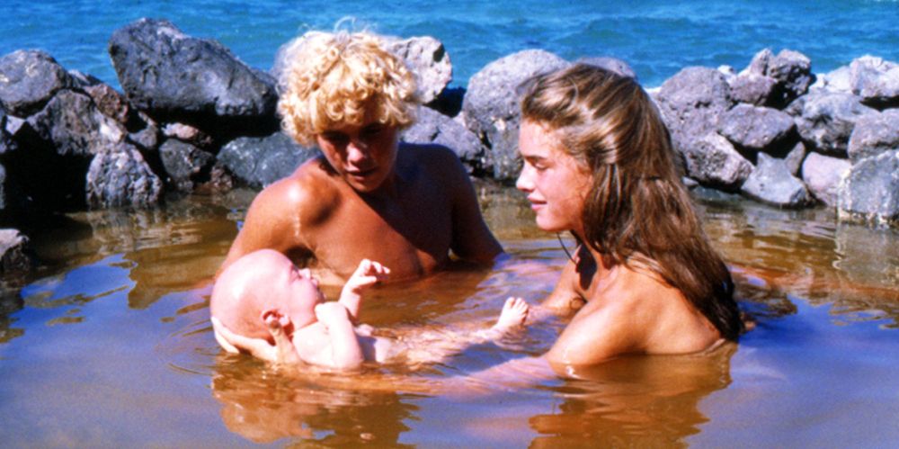 Richard and Emmeline bathe their baby in a pond in The Blue Lagoon