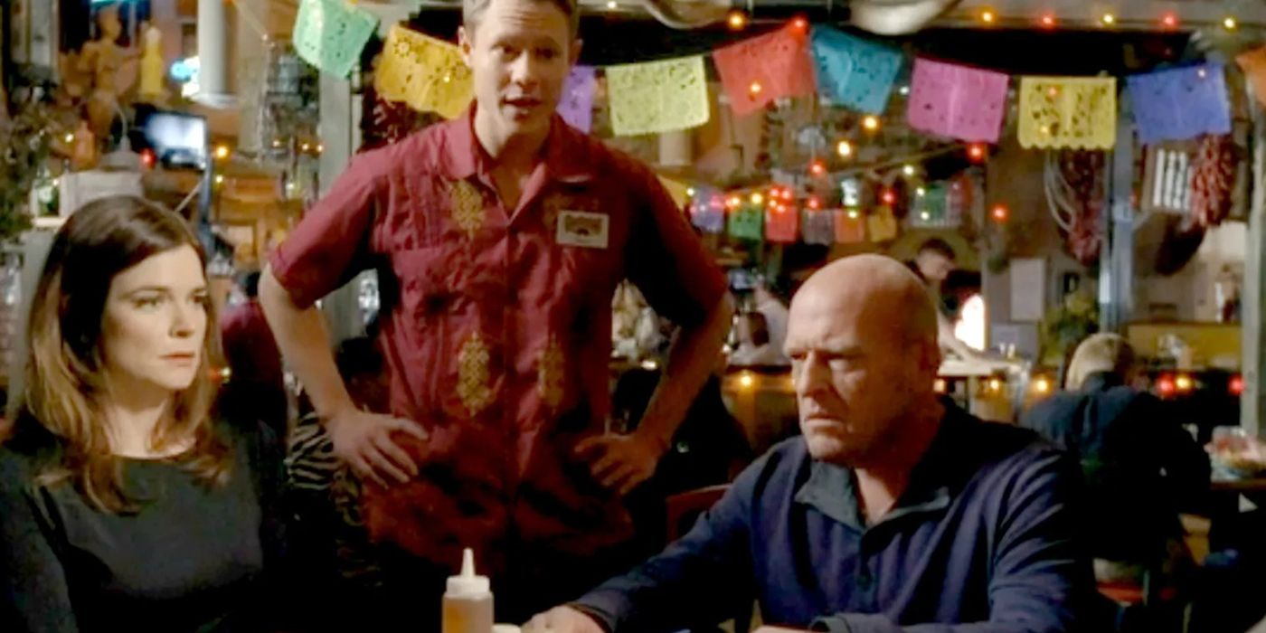 Marie and Hank looking awkward and angry with a waiter standing by the table on Breaking Bad.