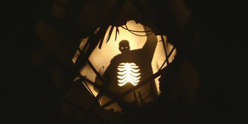 Candyman rips out of a screen as a shadow puppet in the 2021 Candyman movie