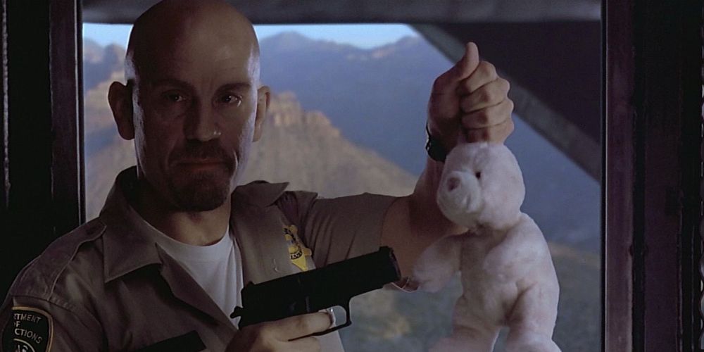 Cyrus points pistol at a toy bunny in Con Air